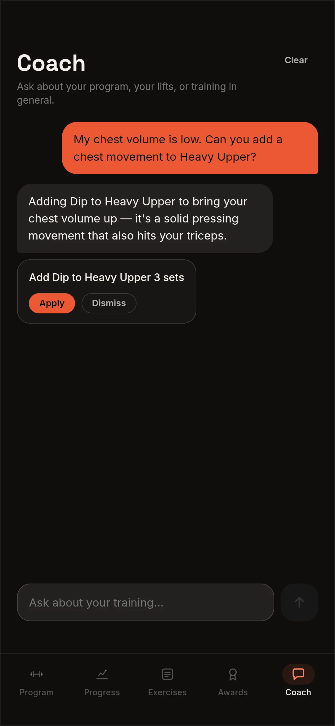 The Alpha Lifts coach asked to add a chest movement to the Heavy Upper day, answering that a Dip brings chest volume up and also works the triceps, then offering the change as a proposal with Apply and Dismiss buttons.